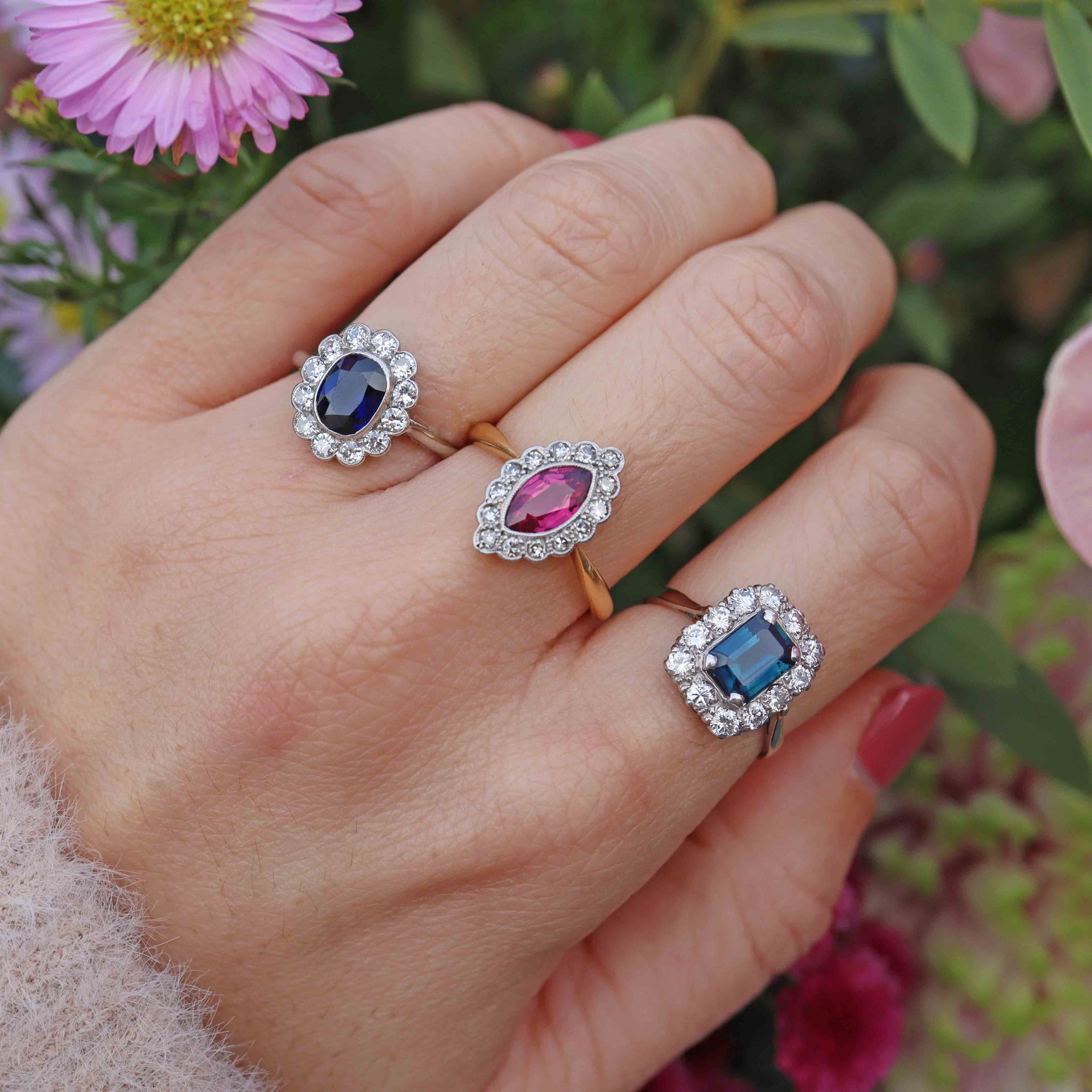 two sapphire rings and one ruby ring