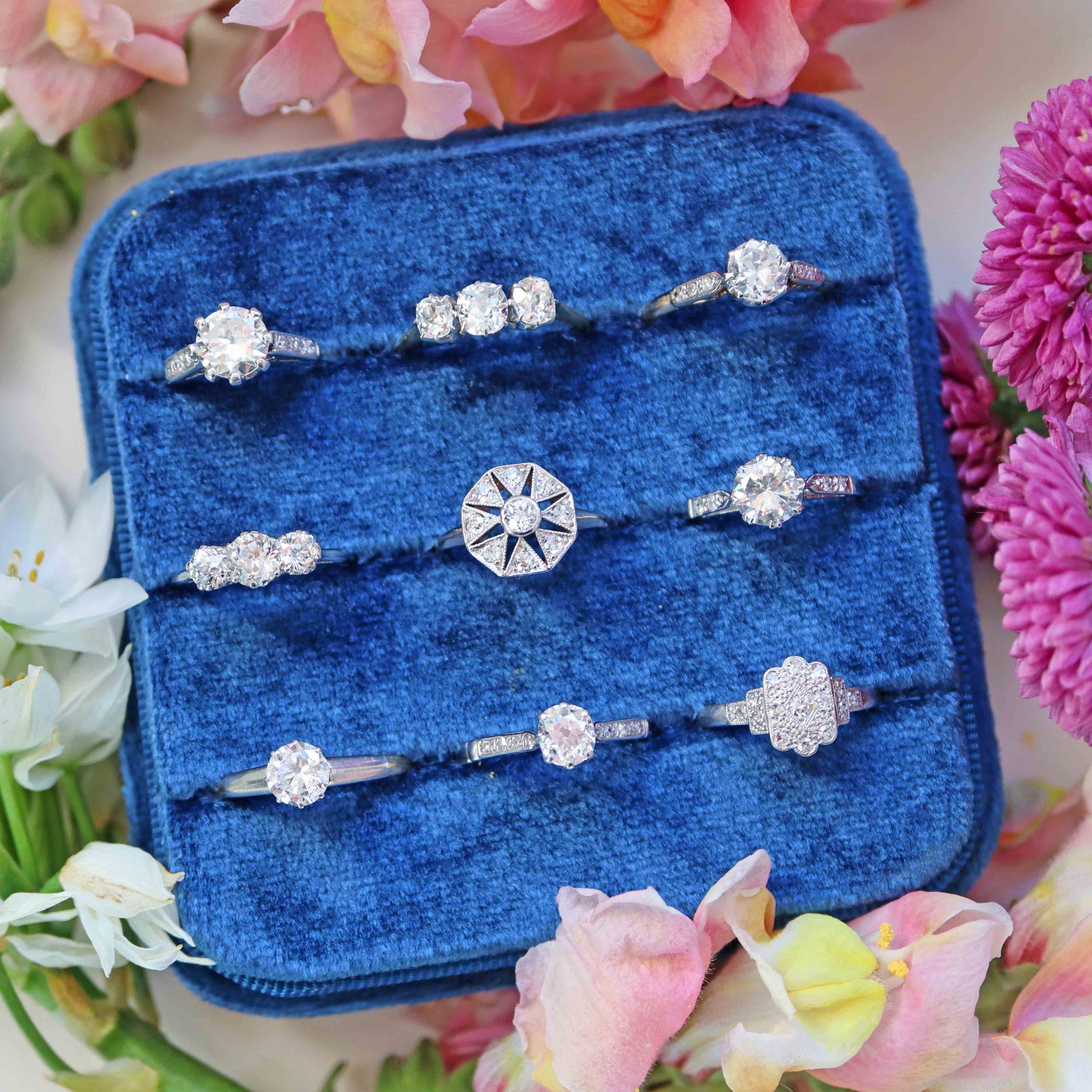 antique diamond rings in a blue tray