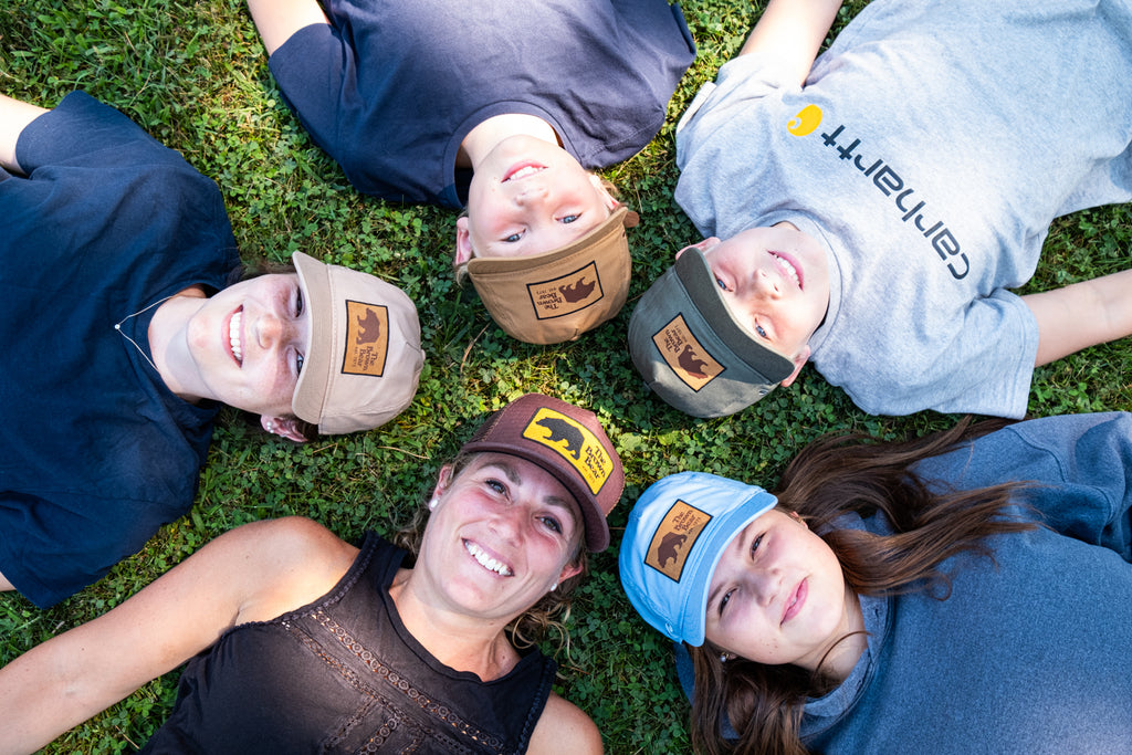 Family wearing matching hats The Brown Bear