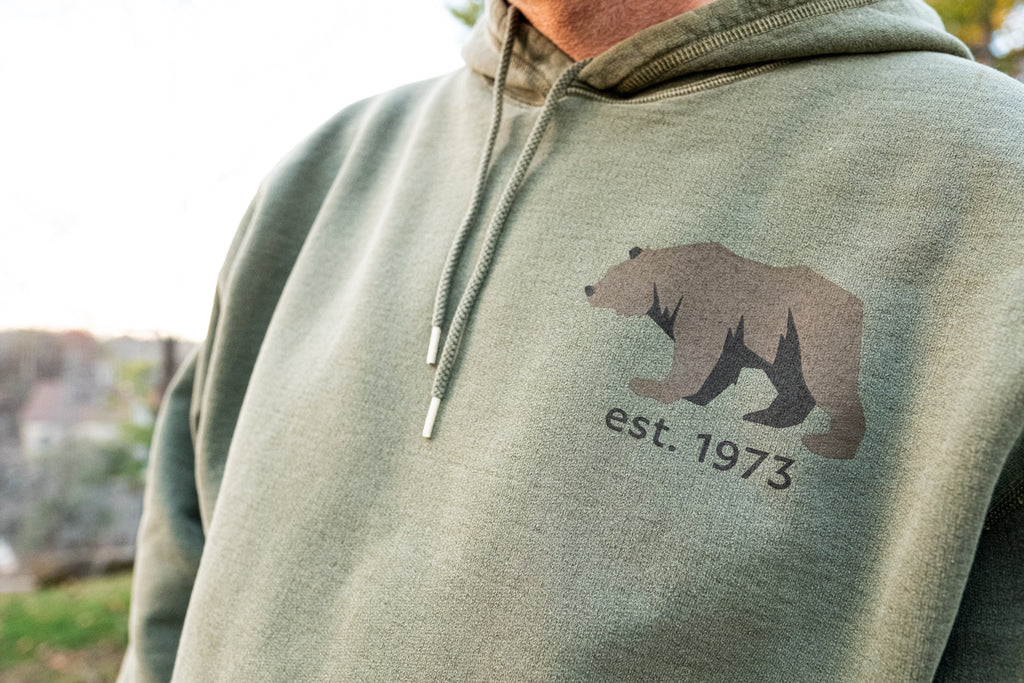 The Brown Bear Logo on an olive green hoodie
