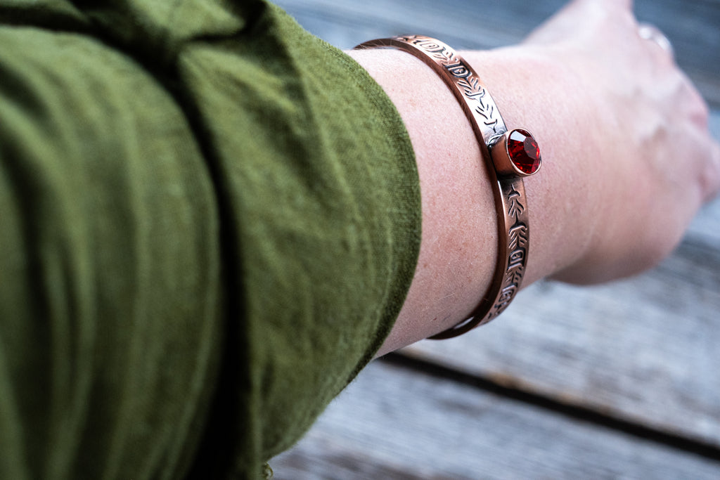 copper bangle 0.4” wide open cuff with engraving on copper plate and a 10mm ruby-coloured crystal