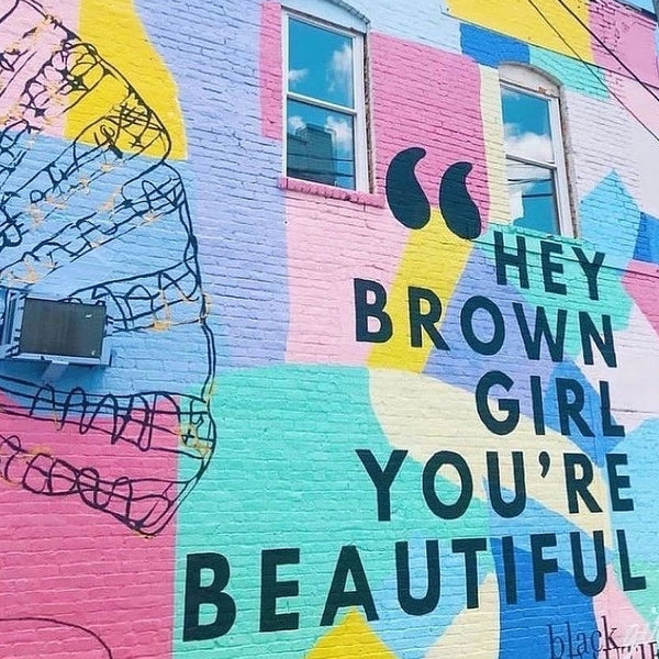 artistic graffiti background with quote hey brown girl you're beautiful