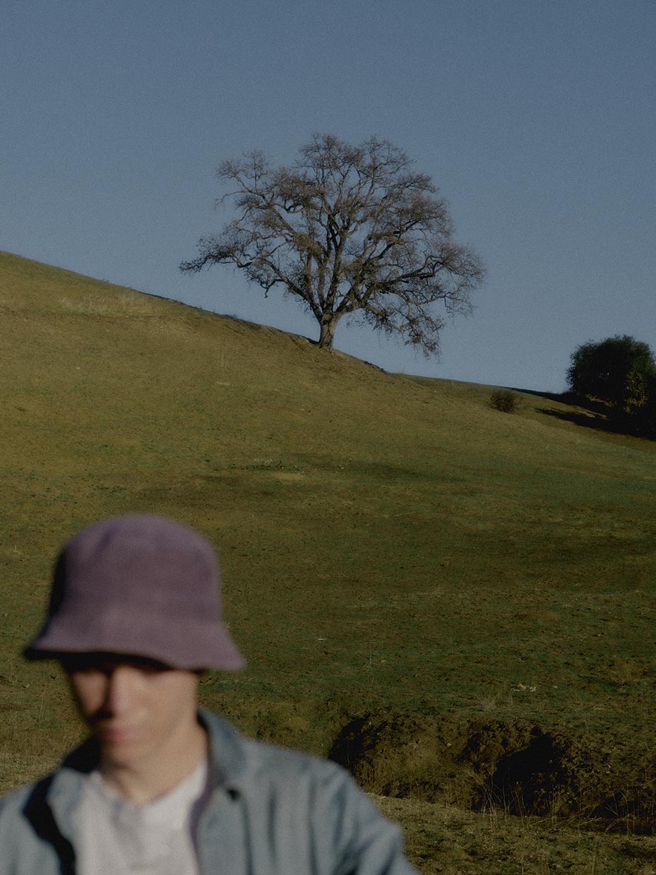 tree with a model walking down a hill