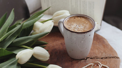Coffee mug on a bedside table - breakfast in bed