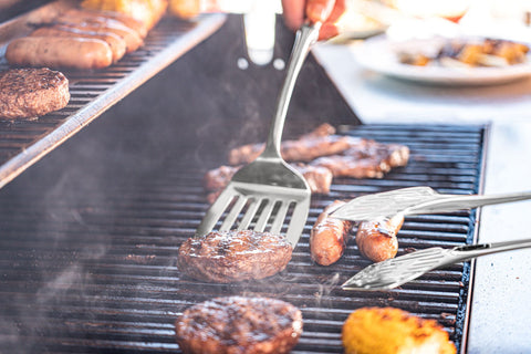 Stainless steel kitchen utensils - fish slice being used at a BBQ