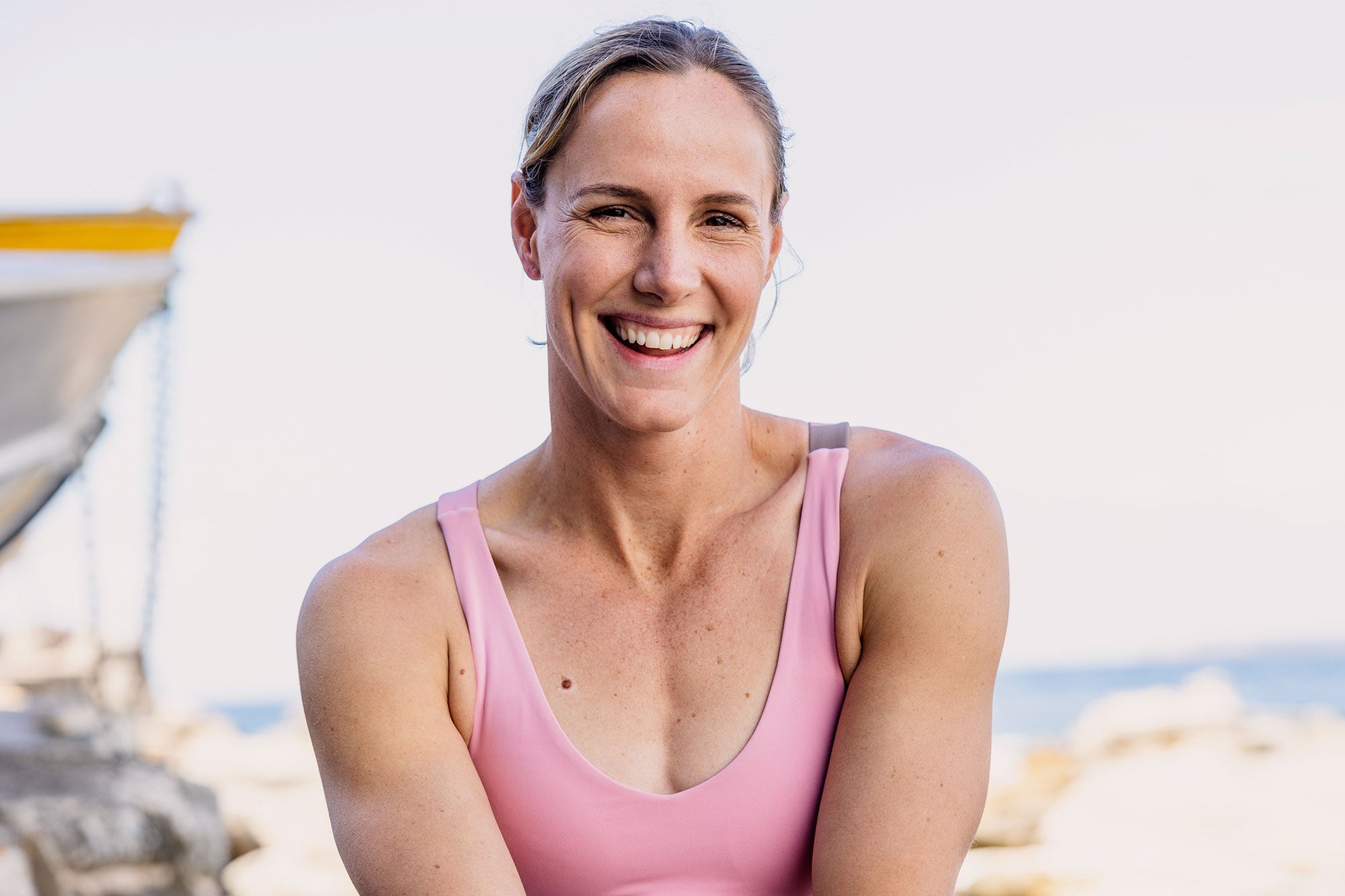 Founder Bronte Campbell wearing a pink Earthletica crop top and smiling broadly at the camera