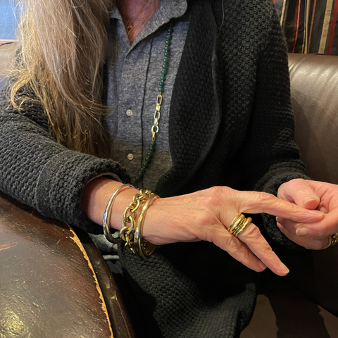 A photo of Liz in her current "everyday" look featuring the minimalist bangles and the 18k gold chain and jade necklace.
