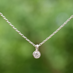 4mm lab grown diamond solitaire necklace set in sterling silver with sterling silver delicate chain.