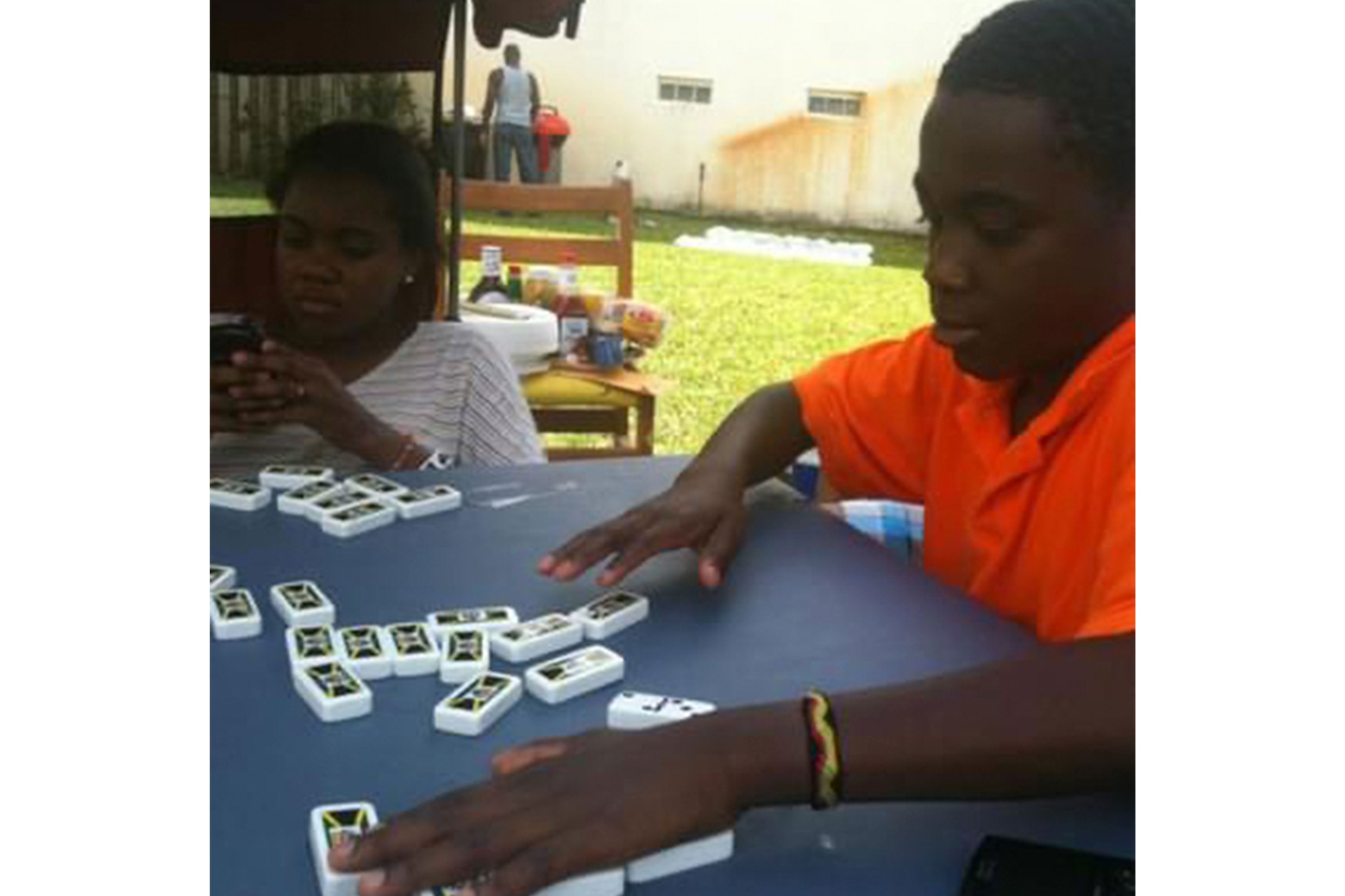 Emmanuel playing dominoes with his sister