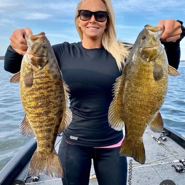 Woman holding two pre-spawn bass