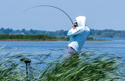 Man setting a hook on with a fish