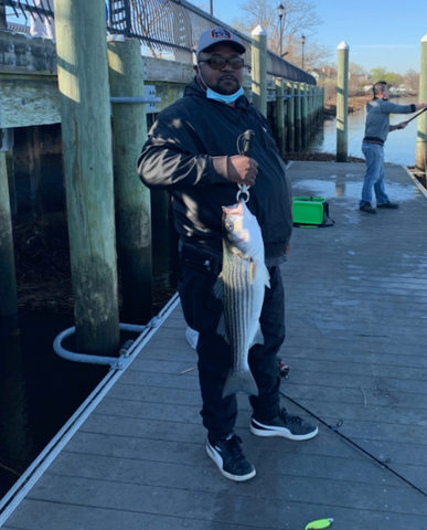 Man with striped bass