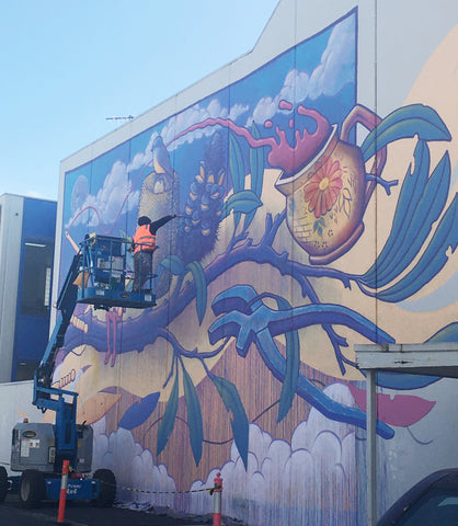 Hayden Dewar on a Cherry Picker painting a mural in Melbourne