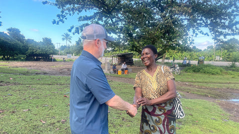 Shawn Askinosie shaking hands with lead farmer Mama Mpoki