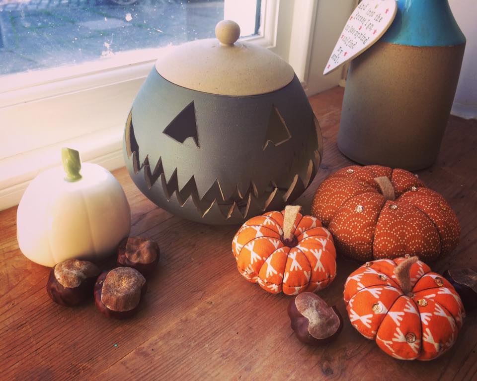 A glazed ceramic lantern pot with a Jack ‘o Lantern design from Glosters pottery classes.