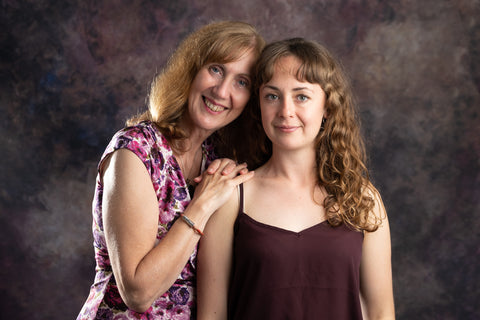 Mother leaning on the shoulder of daughter smiling