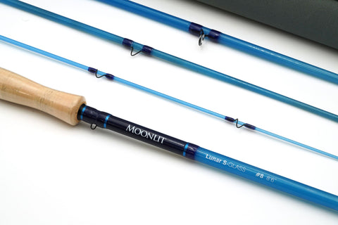 Four fibre glass fishing rods.