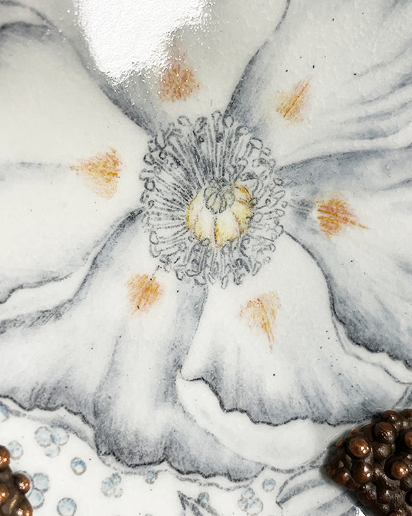 Black and white flower drawing embedded in glass on copper wall sculpture