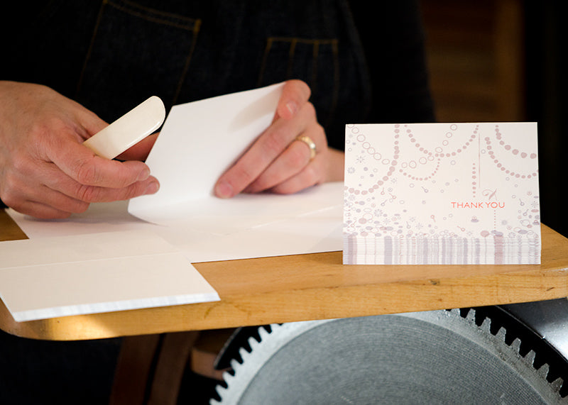 folding cards by hand at Orange House Letterpress, custom Thank You card for CG Jewelry 