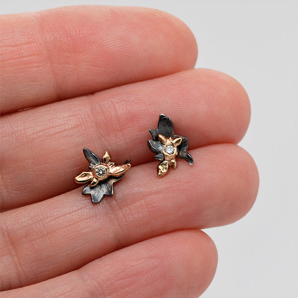 14k yellow gold, diamond, black silver flower burst stud earring. Handmade jewelry inspired by nature, handcrafted in Seattle by artist Catherine Grisez