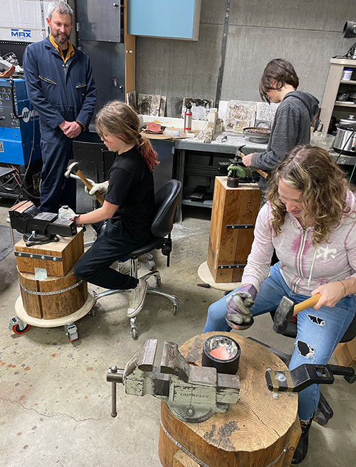 family learning to hammer mini copper bowls in CG sculpture studio