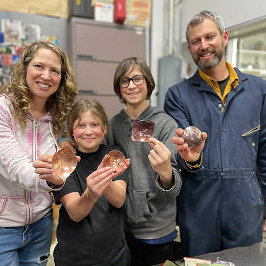 family of 4 with finished mini copper bowls they made in C Grisez metalsmithing studio