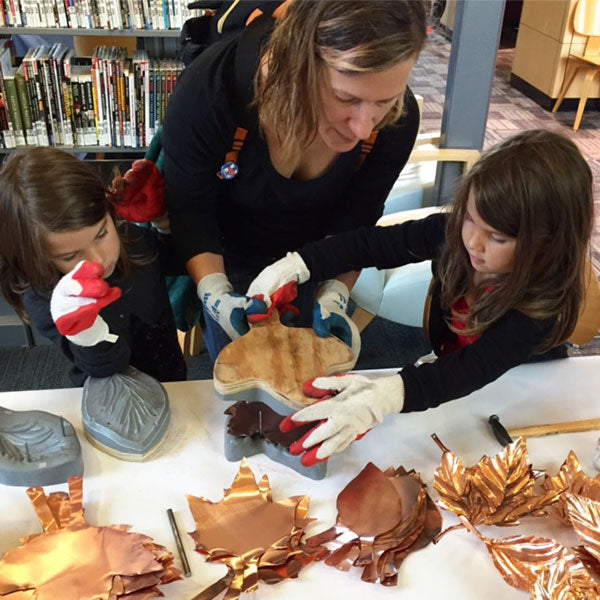 mom and kids making copper leaves for Part You collaborative art installation by Seattle artist Catherine Grisez