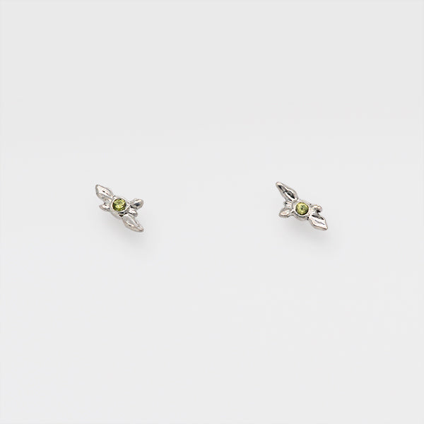 tiny succuleThis is an image of a pair of sculpted peridot earrings studs embossed in sterling silver. nt stud earrings set with peridot, august birthstone jewelry you can wear everyday, handcrafted in Seattle by artist Catherine Grisez