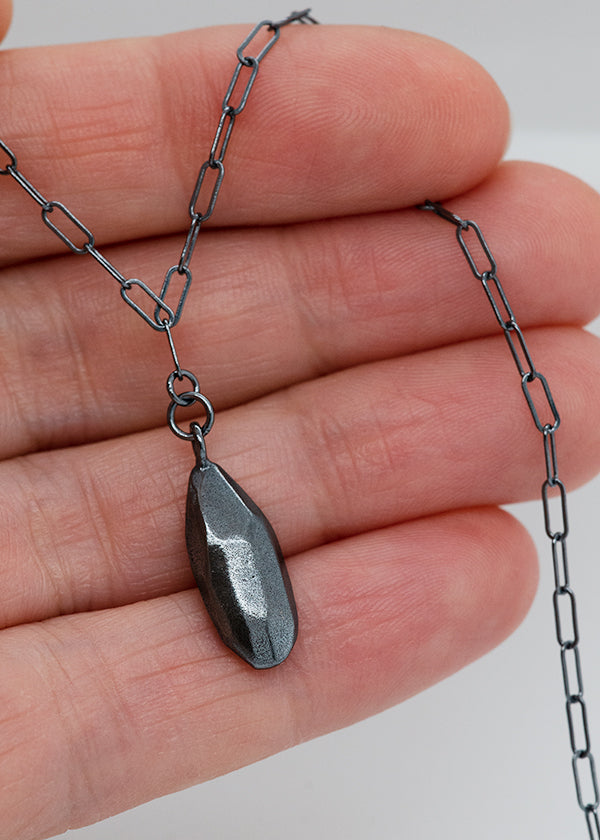 darkened sterling silver rock drop necklace on elongated oval chain handmade by seattle artist Catherine Grisez with CG Sculpture Jewelry