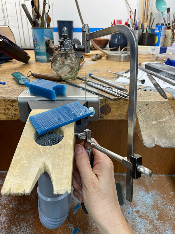 sawing wax block into future tiny flower that will be cast in metal handcrafted jewelry by Catherine Grisez