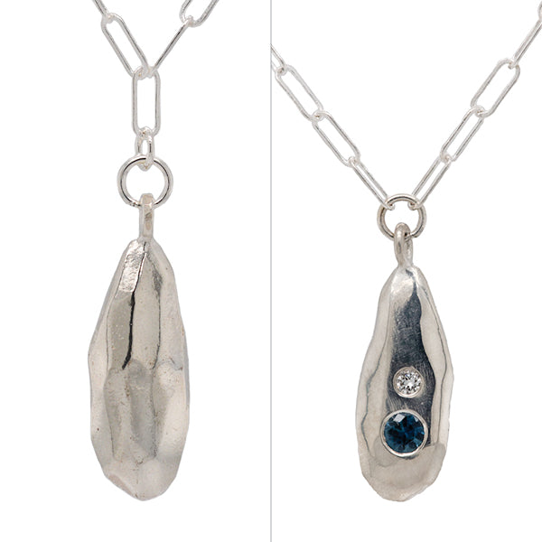 front and back of strength rock droplet necklace with diamond and blue sapphire, artist made in Seattle