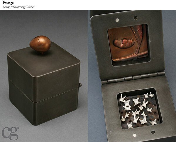 bronze egg with silver butterflies commemorating death - music box sculpture plays amazing grace