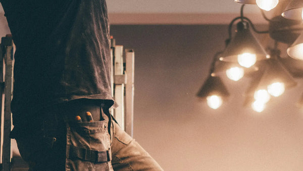 Image of a man installing a luminaire.