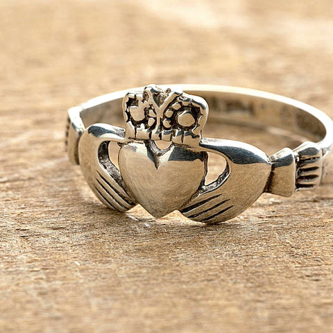 Irish Claddagh ring hands clasping a crowned heart 