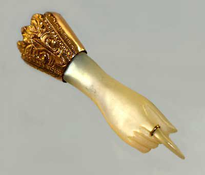 Fine victorian pointing hand brooch in mother of pearl with golden cuff and ring on forefinger