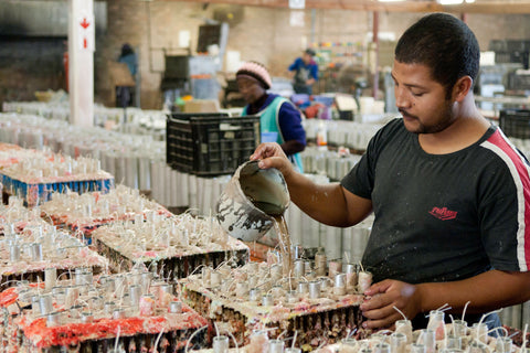 Artisan pouring wax for hand made fair trade candles at Kapula #Blacklivesmatter