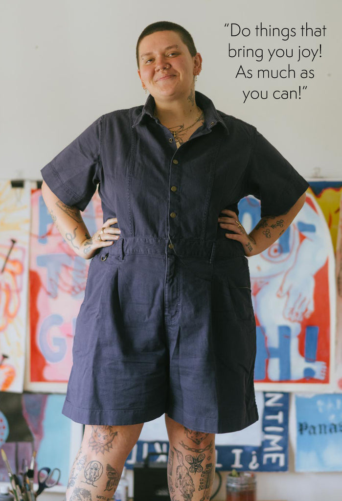 Frances standing up, wearing a Cropped Ringer Suit in Blue. text reads: "Do things that bring you joy! As much as you can!"