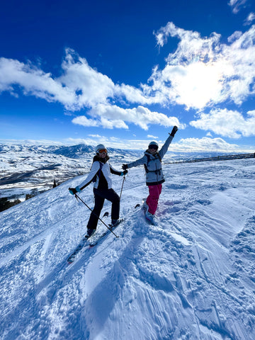 Two women on the side of a mountain at Snowbasin Resort, Utah.