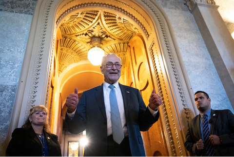 Senate Majority Leader Charles E. Schumer (D-N.Y.) gives a thumbs up as he leaves the Senate chamber after passage of the Inflation Reduction Act on Aug. 7. (Drew Angerer/Getty Images)