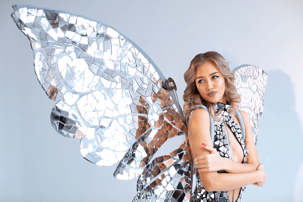 Blonde woman with mirrored angel wings