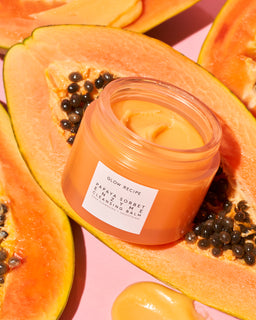 Papaya sorbet enzyme cleansing balm opened on papaya fruit