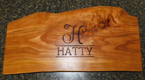Homeowner's last name on a handcrafted charcuterie board made by Springhill Millworks using locally sourced hardwood in Michigan.