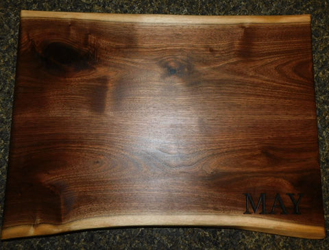 Homeowner's last name on a handcrafted charcuterie board handcrafted and engraved by Springhill Millworks using locally sourced hardwood in Michigan.