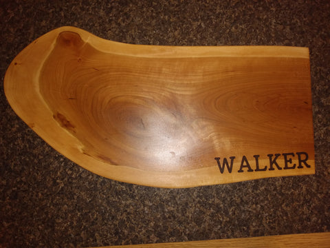 Homeowner's last name on a handcrafted charcuterie board handcrafted and engraved by Springhill Millworks using locally sourced hardwood in Michigan.