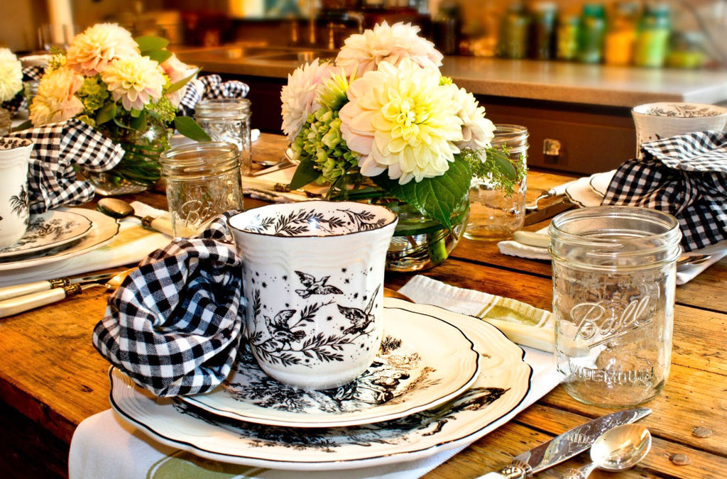 Black and White Toile on a table with green and white kitchen towels as a placemat
