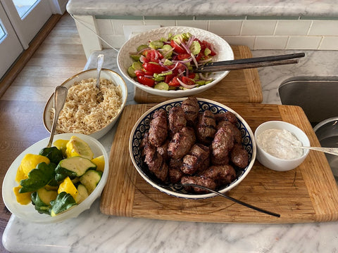 Pilaf, steamed patty pan squash, a Russian salad of tomatoes, cucumbers and red onion dressed in unrefined sunflower oil and Čevapčiči