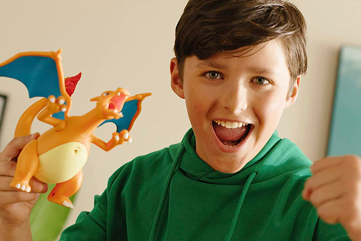 Child playing with Pokemon Battle Figure Charizard