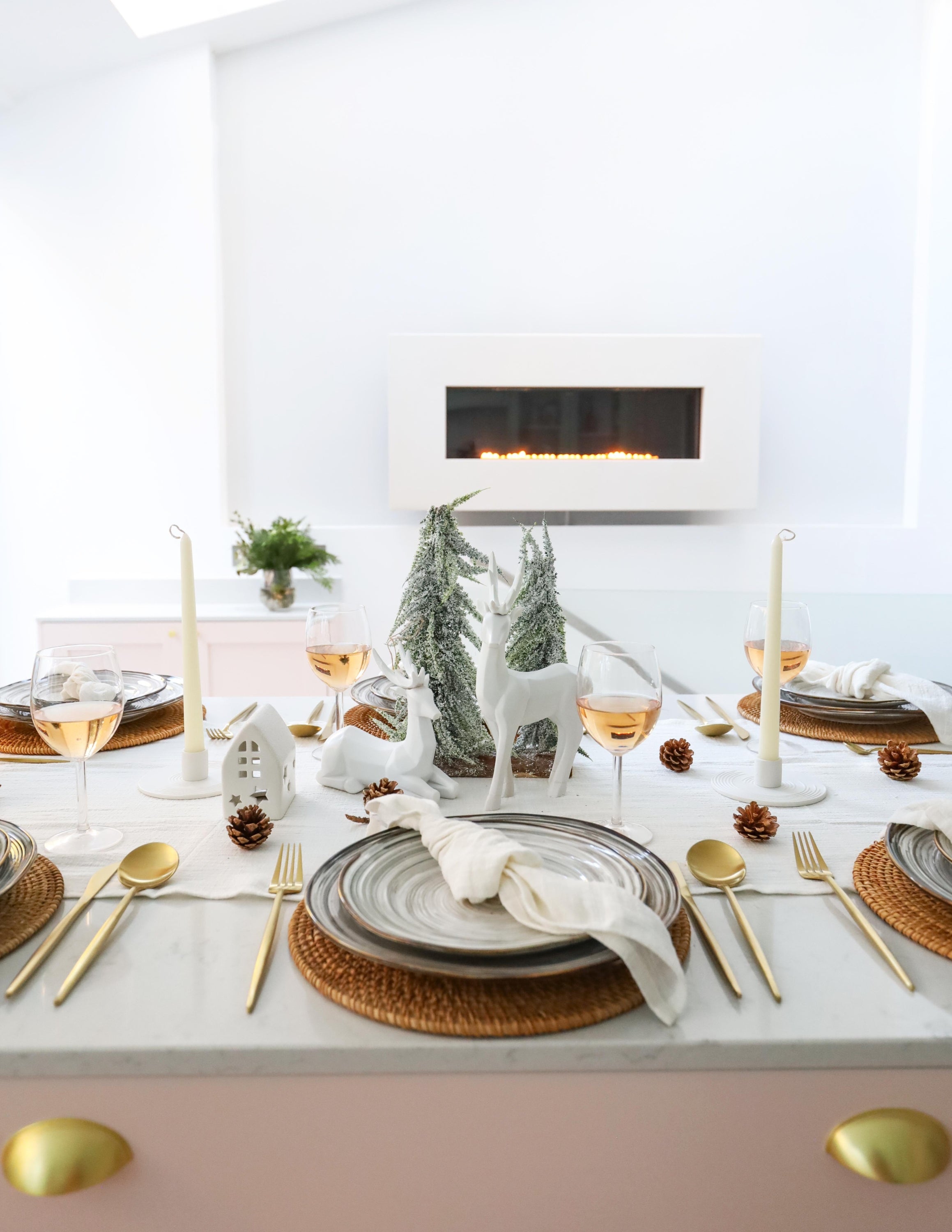 What a Host Home Decor: Christmas Tablescape With Geometric Decorative Christmas Deers, Scandi Houses, Rattan Placemats, Porcelain Plates Set Tableware, Gold Cutlery Stainless Steel Set and Rustic Cotton Gauze Table Textiles