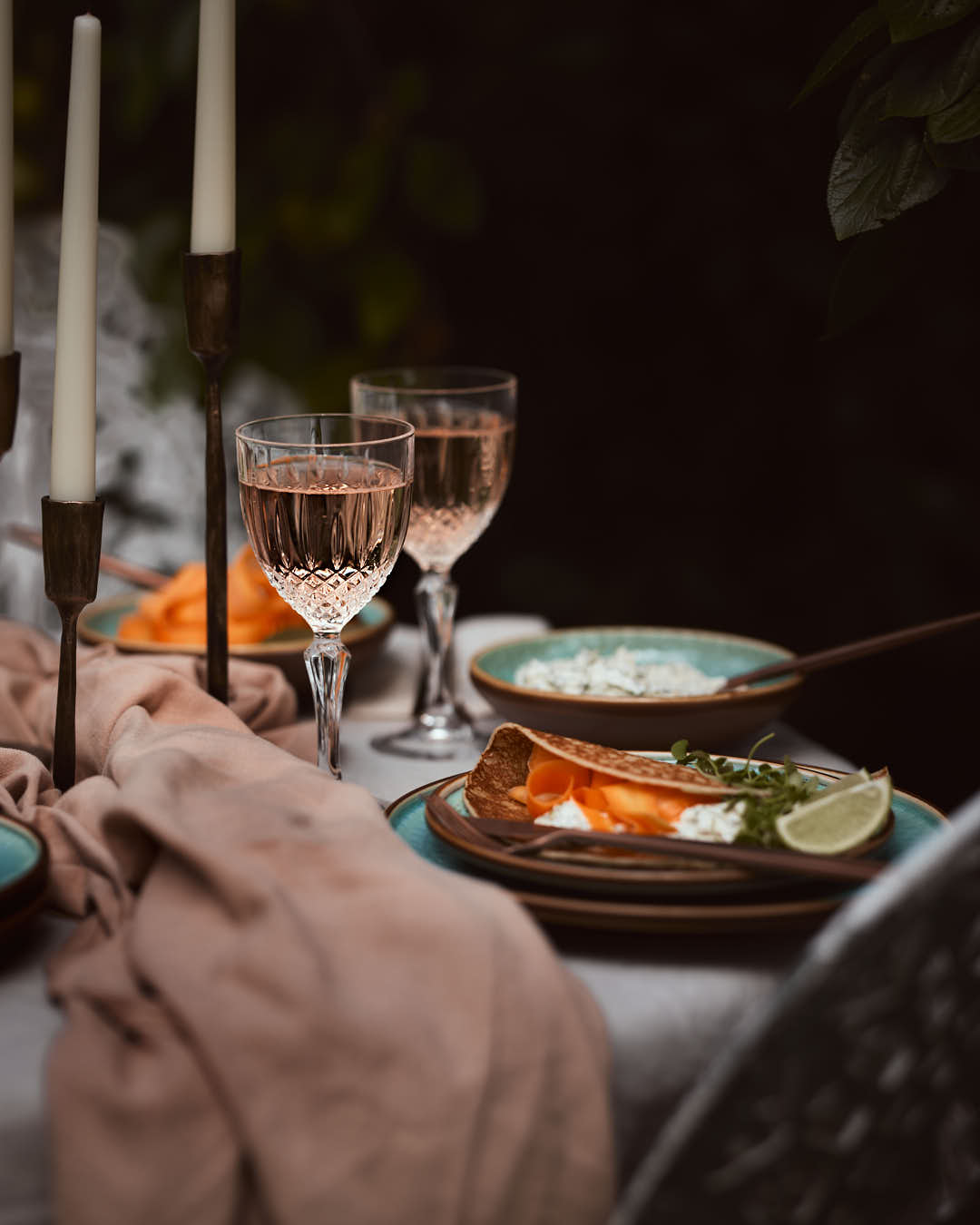 What a Host Home: antique gold brass candle holders, green porcelain plates and blows blended with touches of earth tones, washed linen table textiles (natural material tablecloths and linen napkins) and gold rose cutlery sets.