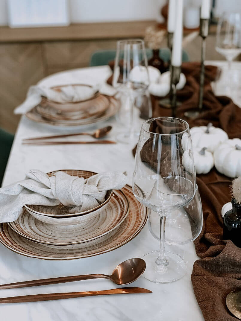 Autumn Tablescape from What a Host Home Decor with cotton gauze table runner, porcelain round plates, cooper stainless steel cutlery, linen napkins and brass candle holders